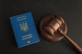 Ukrainian passport and judge gavel on gray black background. Legal immigration. Obtain citizenship Royalty Free Stock Photo