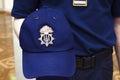 Ukrainian policeman hand holding a blue cap with a coat of arms Tryzub