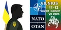 Ukrainian President Volodymyr Zelensky looks at the logo of the NATO summit