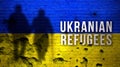 Ukrainian Refugees background. Silhouettes of civilians against Ukrainian flag, cracked and damaged brick wall image