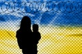 Ukrainian refugees - a mother with a child, near a barbed wire fence Royalty Free Stock Photo