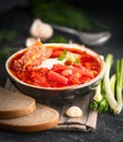 Ukrainian Russian borscht with white beans on the bowl. Plate of red beet root soup borsch on black rustick table Royalty Free Stock Photo