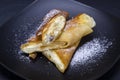 Homemade pancakes stuffed white cottage cheese with raisins on a black plate, close up