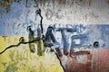 Ukrainian and russian flag painted on concrete wall with the text hate on top. war and conflict concept between russia, nato and u Royalty Free Stock Photo