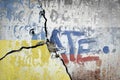 Ukrainian and russian flag painted on concrete wall with the text hate on top. war and conflict concept Royalty Free Stock Photo