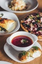 Ukrainian and russian national red borsch with buns and other dishes served on the table Royalty Free Stock Photo