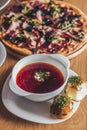 Ukrainian and russian national red borsch with buns and other dishes served on the table Royalty Free Stock Photo