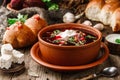 Ukrainian and Russian traditional beet root soup or borscht in bowl with rib eye meat, sour cream, buns, goat cheese, garlic, Royalty Free Stock Photo