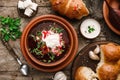 Ukrainian and Russian traditional beet root soup or borscht in bowl with rib eye meat, sour cream, buns, goat cheese, garlic, Royalty Free Stock Photo