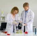 Ukrainian scientist are carefully adjusting Stand and Clamp for an experiment in laboratory. Young Brazilian scientist holding