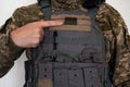 Ukrainian soldier in military pixel unform and bulletproof vest jacket and finger.