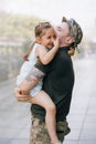 Ukrainian soldier returning from the war meets his little daughter and joyful embraces her