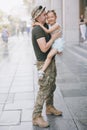 Ukrainian soldier returning from the war meets his little daughter and joyful embraces her