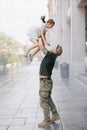 Ukrainian soldier returning from the war meets his little daughter and joyful throws the child up