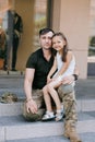 Ukrainian soldier returning from the war meets his little happy daughter and embraces her