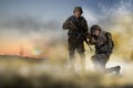 Ukrainian soldiers with machine guns on battlefield