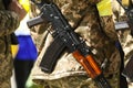 Ukrainian Territorial Defense Military with a yellow bandage and a Kalashnikov rifle