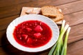 Ukrainian traditional beetroot soup - Borscht with bread, slices of bacon and onion on wooden table, food concept Royalty Free Stock Photo