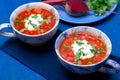 Ukrainian traditional borsch. Russian vegetarian red soup in blue bowl on blue wooden background. Borscht, borshch with beet. Tw Royalty Free Stock Photo