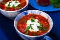 Ukrainian traditional borsch. Russian vegetarian red soup in blue bowl on blue wooden background. Borscht, borshch with beet. Tw Royalty Free Stock Photo