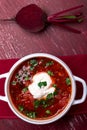 Ukrainian traditional borsch. Russian vegetarian red soup in white bowl on red wooden background. Top view. Borscht, borshch wit Royalty Free Stock Photo