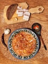 Ukrainian traditional food Borsch in national hand-painted plate. Food flat lay at wooden table Royalty Free Stock Photo