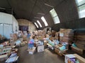 Ukrainian volunteers sorting boxes with humanitarian aid on warehouse