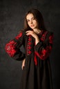 Ukrainian woman in a black embroidered dress on a dark background