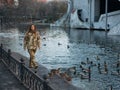 Ukrainian woman soldier walking in park during her vacation near of lake and ducks