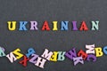UKRAINIAN word on black board background composed from colorful abc alphabet block wooden letters, copy space for ad text. Royalty Free Stock Photo