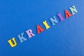 UKRAINIAN word on blue background composed from colorful abc alphabet block wooden letters, copy space for ad text. Learning