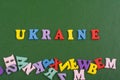 UKRAINIAN word on green background composed from colorful abc alphabet block wooden letters, copy space for ad text