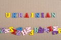 UKRAINIAN word on paper background composed from colorful abc alphabet block wooden letters, copy space for ad text