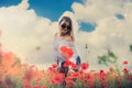 ukrainian young lady in white blouse in the field of poppies Royalty Free Stock Photo