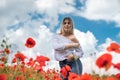 ukrainian young lady in white blouse in the field of poppies Royalty Free Stock Photo