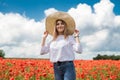 ukrainian young lady in white blouse in the field of poppies Royalty Free Stock Photo