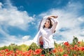 Ukrainian young  lady in white blouse in the field of poppies Royalty Free Stock Photo