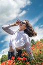 Ukrainian young  lady in white blouse in the field of poppies Royalty Free Stock Photo