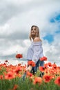 ukrainian young lady in white blouse in the field of poppies Royalty Free Stock Photo