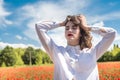 ukrainian young lady in white blouse in the field of poppies Royalty Free Stock Photo