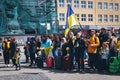 Ukrainians with national flags honor civilians killed in the war in Ukraine.