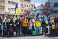 Ukrainians with national flags honor civilians killed in the war in Ukraine.