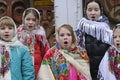 Ukrainians sing Christmas carols as they carry a huge decorated star of Bethlehem and sheaves of wheat in their hands during a