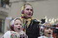 Ukrainians sing Christmas carols as they carry a huge decorated star of Bethlehem and sheaves of wheat in their hands during a