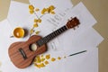 Ukulele with autumn leaves and notes close-up