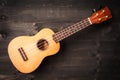 Ukulele on black wooden background. Acoustic music instruments. T Royalty Free Stock Photo