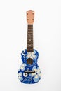 Ukulele with blue flowers. Royalty Free Stock Photo