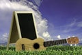 Ukulele with blue sky and Blackboard 2015 text on the grass. Royalty Free Stock Photo
