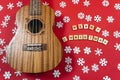 Ukulele with copy space Christmas guitar on a red background. An invitation to New Year's musical concert. Concert on Royalty Free Stock Photo