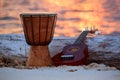 Ukulele and ethnic drum on a beach. Royalty Free Stock Photo